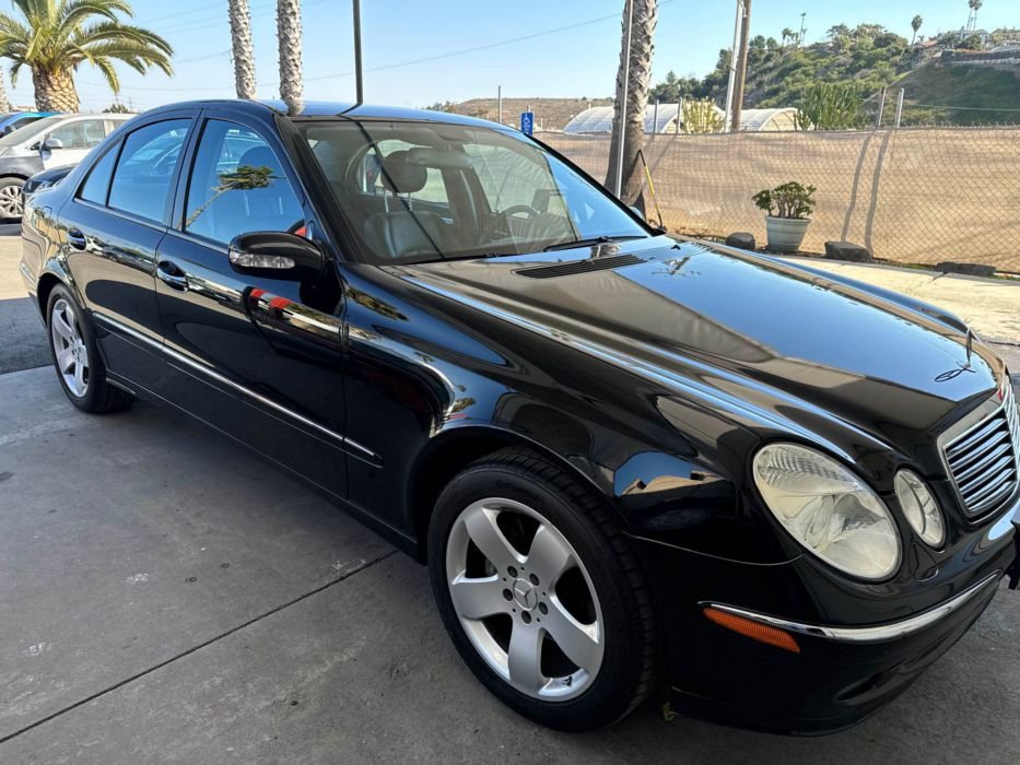 Black Mercedes sedan after repair
